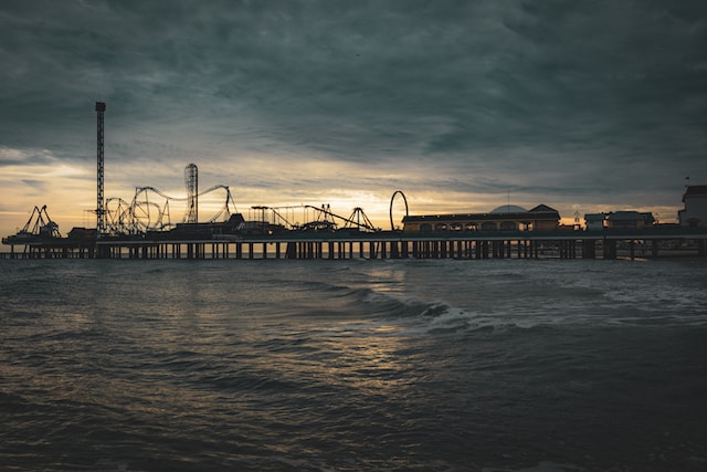 A pier with a roller coaster in the Galveston Port Houston, TX